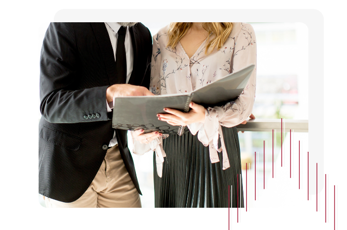 Picture of man and woman reviewing documents with red arrow overlay