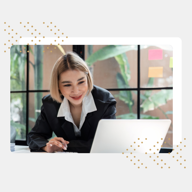 Woman looking at computer while smiling