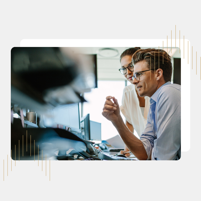 Man and woman looking at computer in office setting